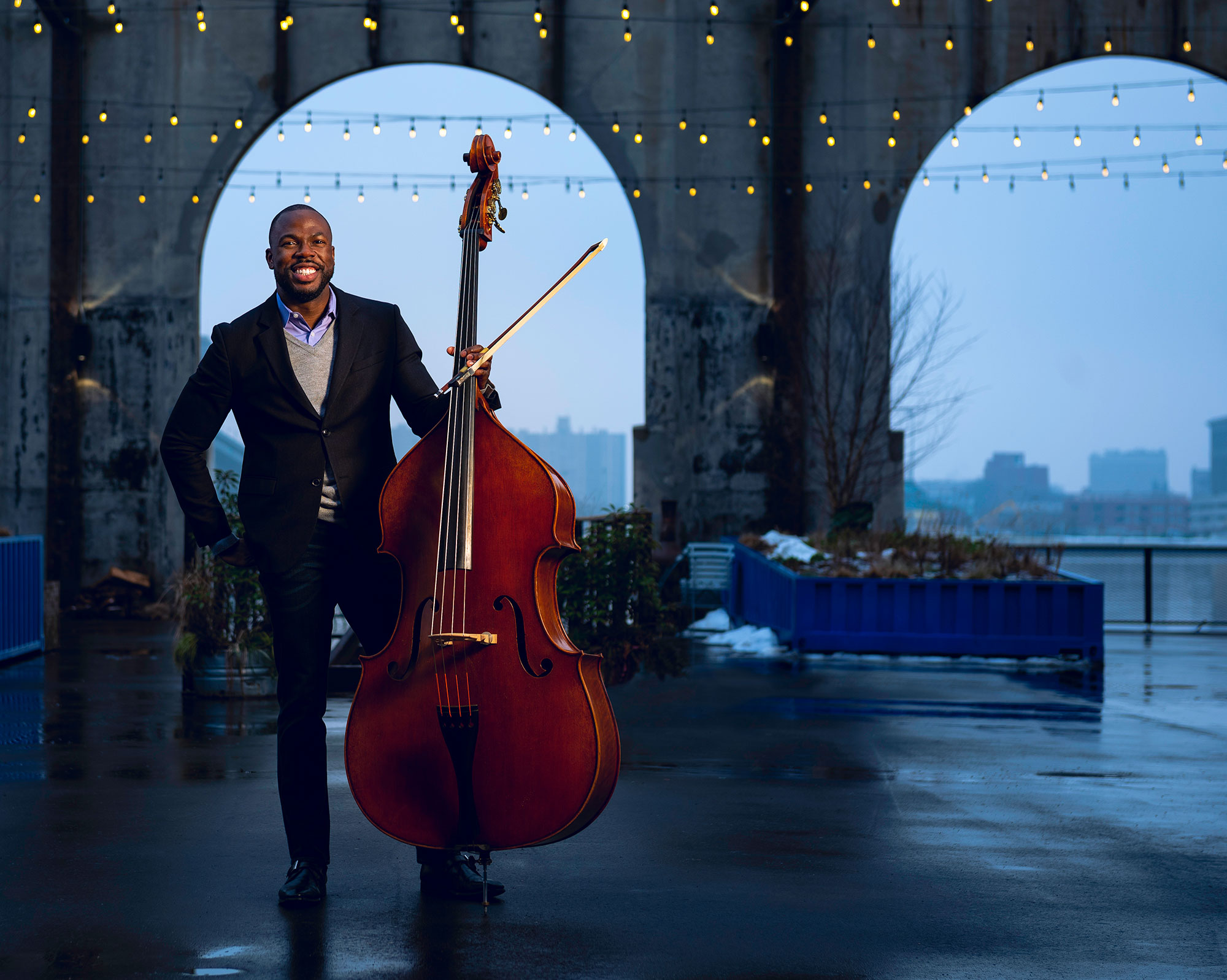 Joseph Conyers (BUTI'98), director of orchestra program at BUTI, holding a bass.