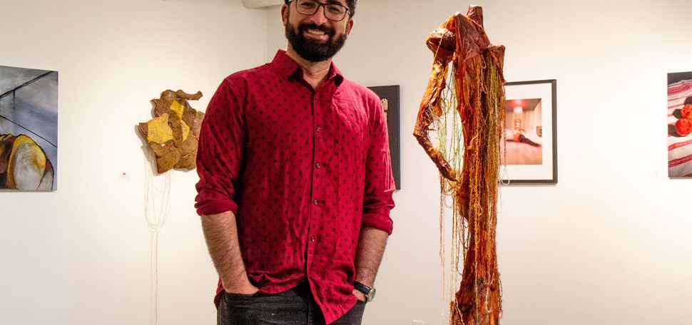 Kamal Ahmad (CFA’16) standing inside Piano Craft Gallery, where he is the curator and director.