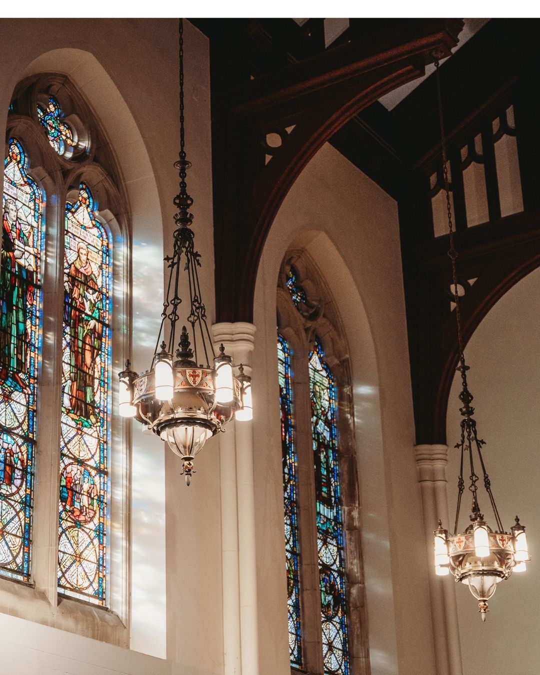 Artistic photo of the chapel stained glass windows and chandeliers