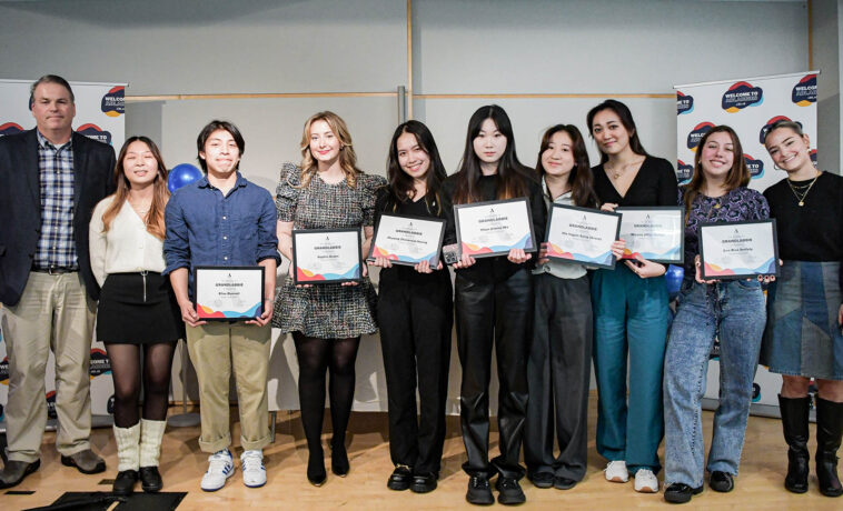 The Grandlabbie Award recipients pose for a picture standing while holding their award plaques.