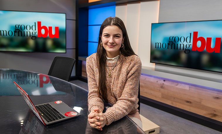 Alex Dowd seated at the anchor desk.