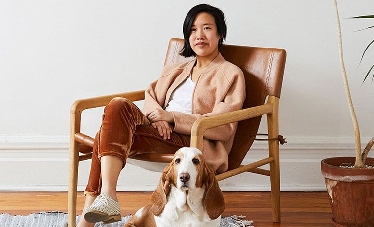 Winnie Clementine seated with a basset hound at her feet.