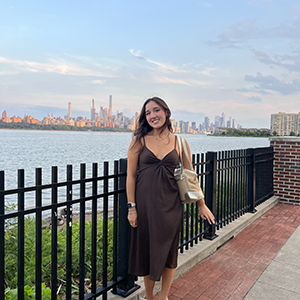 Smiling full body portrait with skyline background