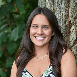 A portrait photo of Amanda Ciminello in front of a tree.