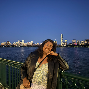 A photo of Diya Kapoor leaning on a handrail.
