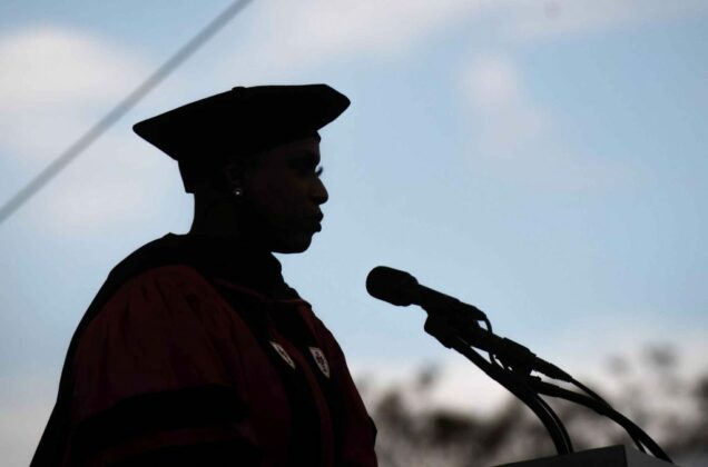 Silhouette of US Representative Ayanna Pressley against a blue sky as she delivers her address to graduating seniors at BU's 2021 Commencement for undergraduate degrees.