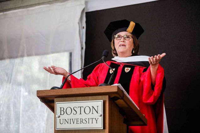 Catherine D’Amato addressing graduates from a podium.