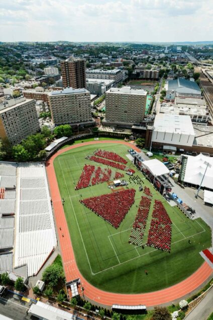 Aerial view of Nickerson Field during the 2021 BU Commencement cermony for undergradate degrees. Only graduating students were allowed to attend the ceremony so students are visible on the field, but nobody is in the bleachers.