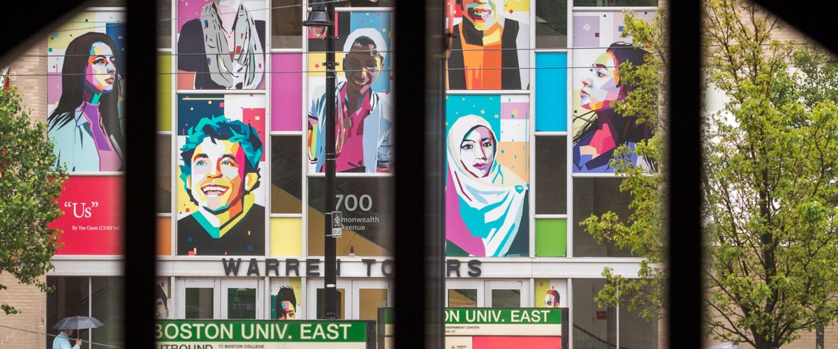 A mural of face in front of the Warren Towers dormitory building