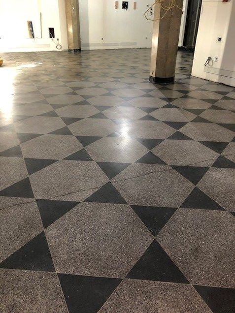 Stripping and cleaning of existing terrazzo flooring.