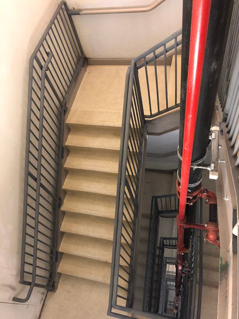 Newly installed hand railings in Stair 1, awaiting painting