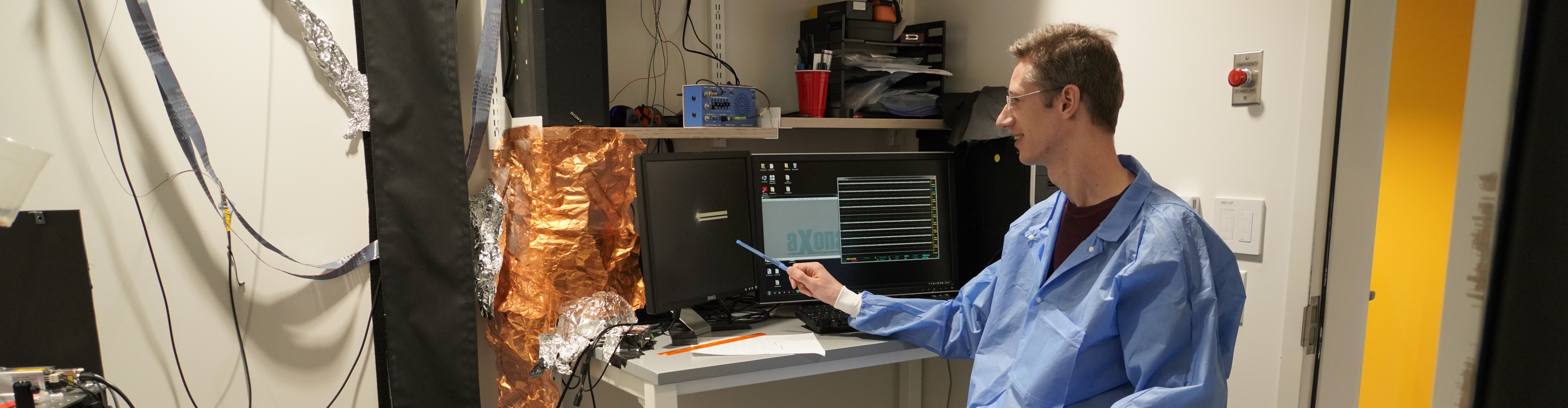 Person working in a lab pointing at their computer screen