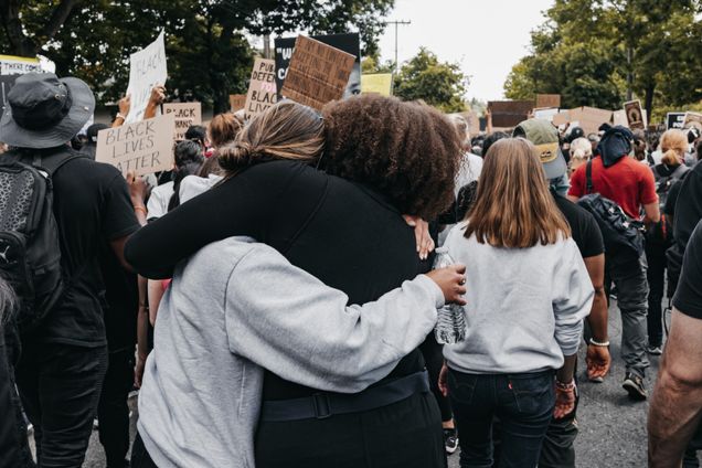 Protestors at Black Lives Matter Protests, two women hugging