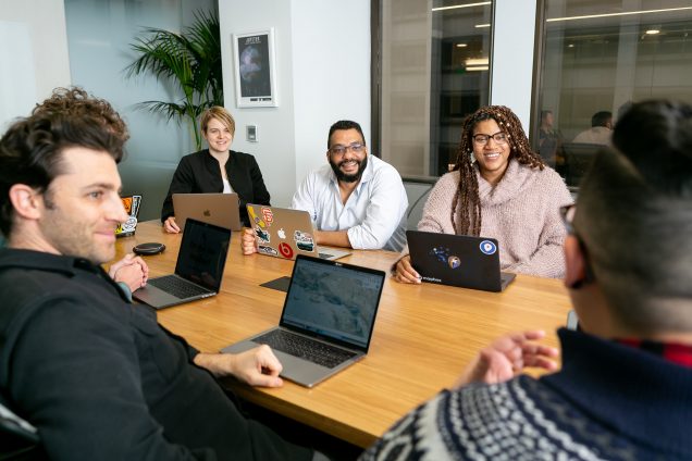 Diverse group of people seated around an office table