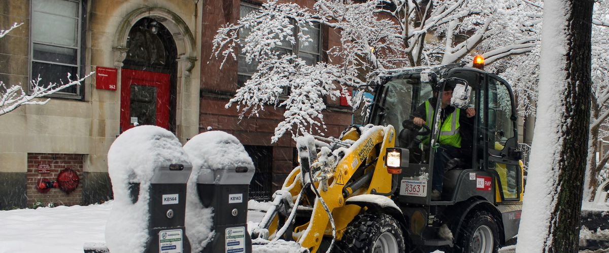BU Facilities worker removes snow on Bay State Road