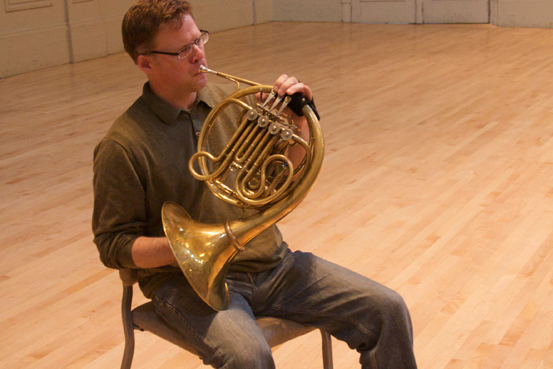 person playing french horn