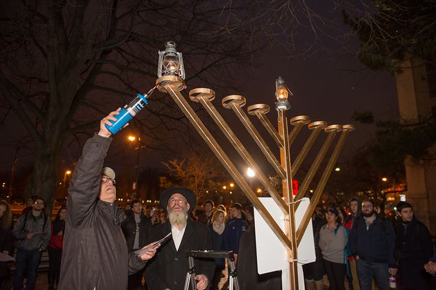 Lighting the menorah on the first night of Hanukkah