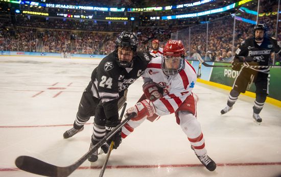 BU's Brandon Hickey (CGS'18) races Providence's Noel Acciari to the puck during Saturday night's NCAA Frozen Four Championship Game at TD Garden. Photo by Cydney Scott