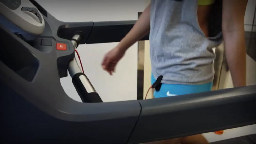 excercising on a treadmill with safety clip attached
