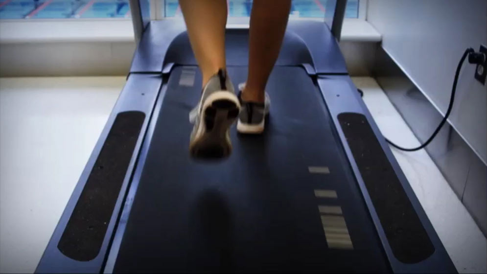 feet walking on a exercise treadmill