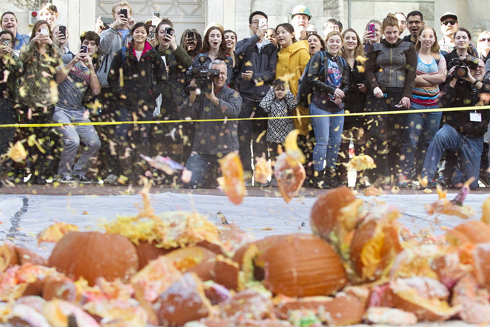 A crowd watches as pumpkins drop from the roof of Metcalf Science Center on Friday, October 30, 2015 during the annual physics department pumpkin drop. Photo By Jackie Ricciardi
