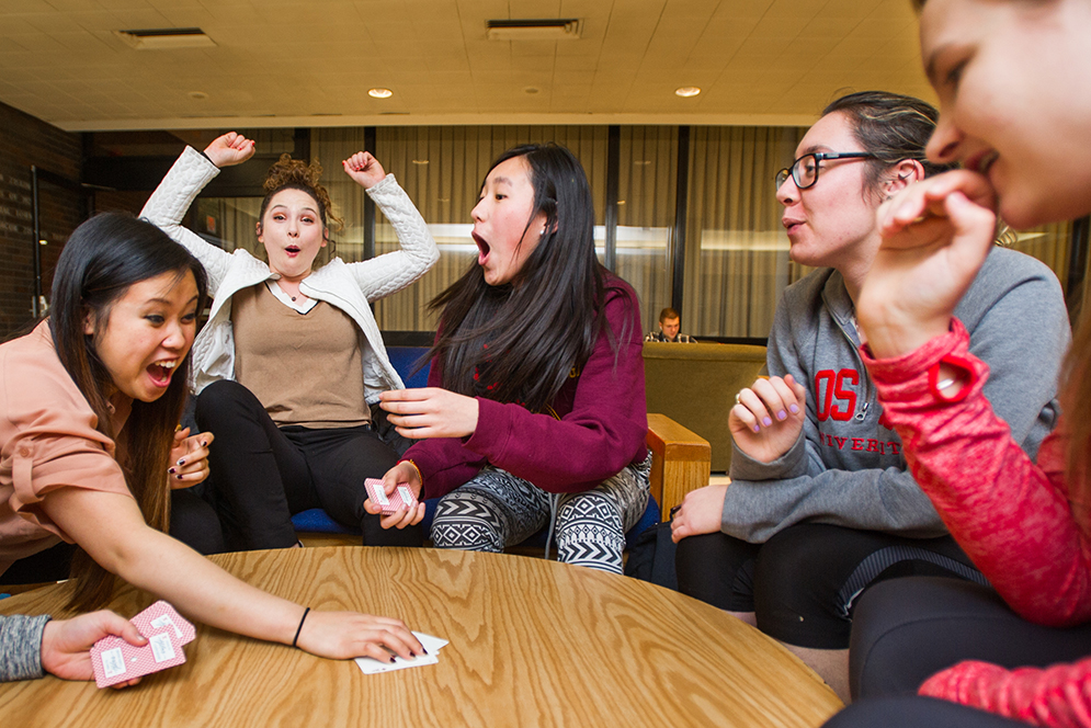 Alpha Phi Omega "brothers" Jessie Leafmeeker (SED'17) from left, Rebecca Barton (SED'18), Diana Parker (COM'18), Emily Hou (CAS'17), Michelle Grbic (SAR'16) and Sarah Eldredge (CAS'17) get competitive with a game of Egyptian Ratscrew at the GSU's Ziskind Lounge February 24, 2016. Photo by Cydney Scott