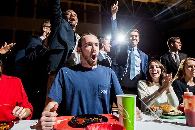 Joe Kass (CAS '18) (center) celebrates after eating his way through a triple bacon cheeseburger, a basket of fries, a root beer and an eight-scoop ice cream sundae in less than 30 minutes to win the campus-wide Rhett's Challenge. The Sigma Phi Epsilon fraternity hosted the event to raise money for the Big Brothers Big Sisters of America organization. Photo by Alexandra Wimley (COM '17)