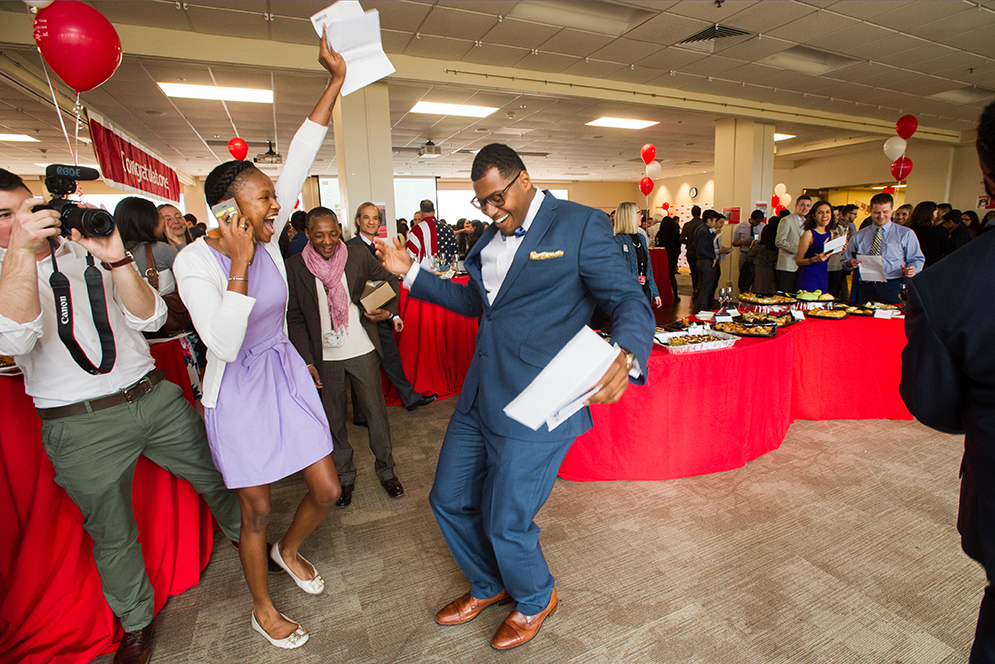 Jaurel Harley (MED'16), left, and Jason Sherer (MED'16) celebrate the next phase as they learn where they will have their medical residencies during Match Day March 18, 2016. Harley is headed to USF Tampa, while Sherer will stay local at BMC. Photo by Cydney Scott