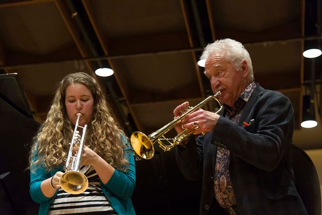 Grammy Award-winning American pop and jazz trumpeter Doc Severinsen, best known for leading the NBC orchestra on <em>The Tonight Show with Johnny Carson</em>, conducted a special masterclass. Here he works with student Janet Christensen (CFA’17). Photo by Kalman Zabarsky