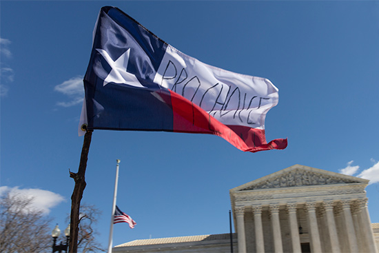 texas flag with Pro Choice message waves in front of the US Supreme Court