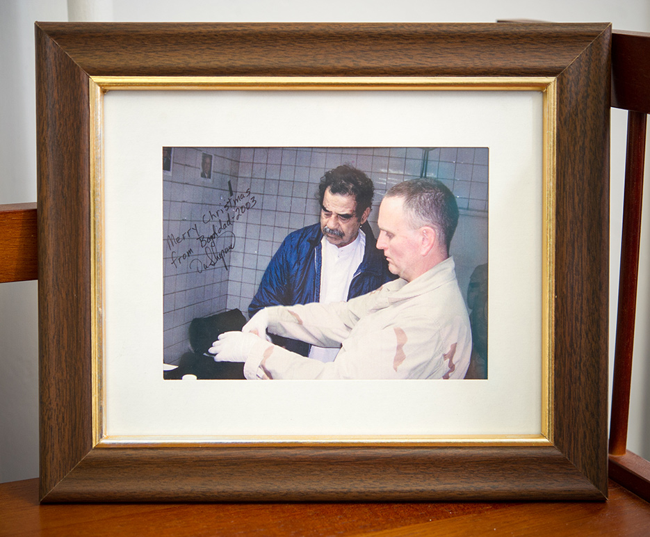 Framed photo of Saddam Hussein being fingerprinted after being captured by American military forces in the office of John Woodward, professor of international relations at Boston University Pardee School of Global Studies