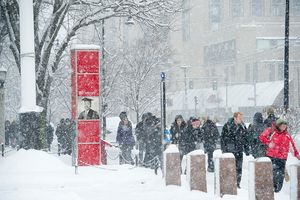 Photo of students walking on campus during a snow storm