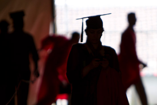 Silhouette of graduating students in cap and gown
