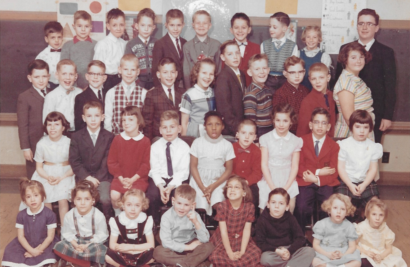 Raymond Kenney stands in the back row, far right, a bright adolescent in a class of elementary-age students. Kenney is deaf but had no access to sign language in school, so he had limited opportunities to advance.