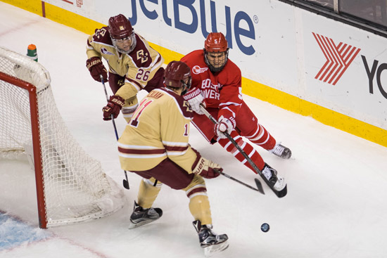 BU Men's Hockey player vs. two BC players behind net