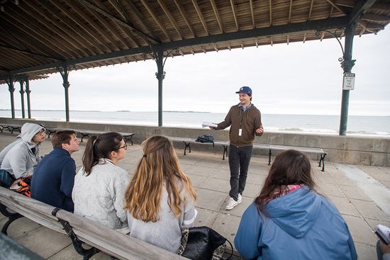 Samuel Palfreyman lecturing students on beach boardwalk