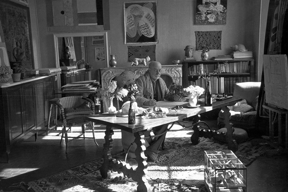 Matisse sitting at his desk