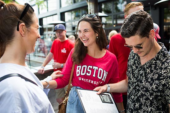 Graduate students enrolled in the Norway Entrepreneurship Program at Boston University Questrom School of Business talk during a social outing in Boston