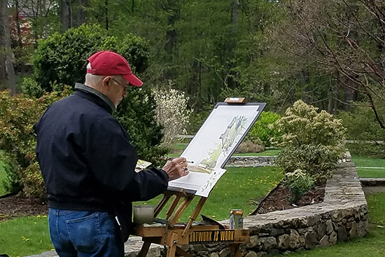 Man painting on art canvas in the outdoors