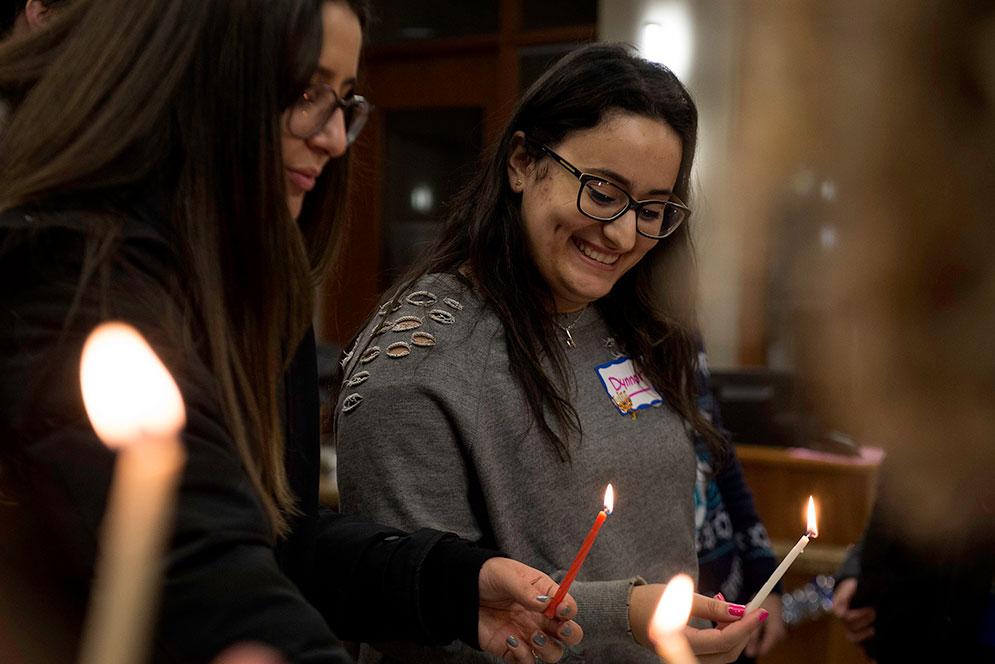 Dynnor Shebshaievitz (CGS’18) and other students marked the first night of Hanukkah at BU Hillel