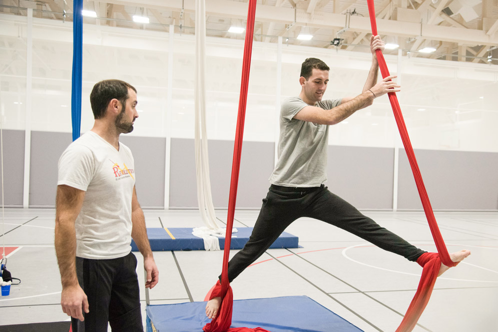 A student performs on aerial silks at FitRec