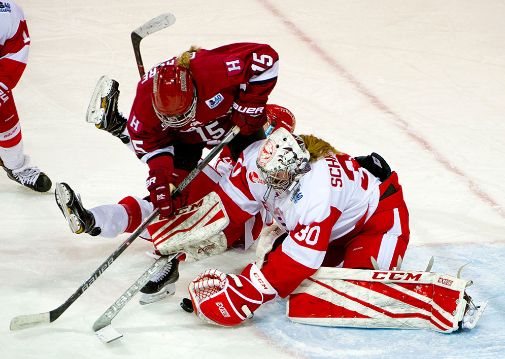 Boston University goalie Corinne Schroeder covers up the puck to make a save as Boston University takes on Harvard in the Women's Beanpot at the Conte Forum at Boston College on Feb. 6, 2017.