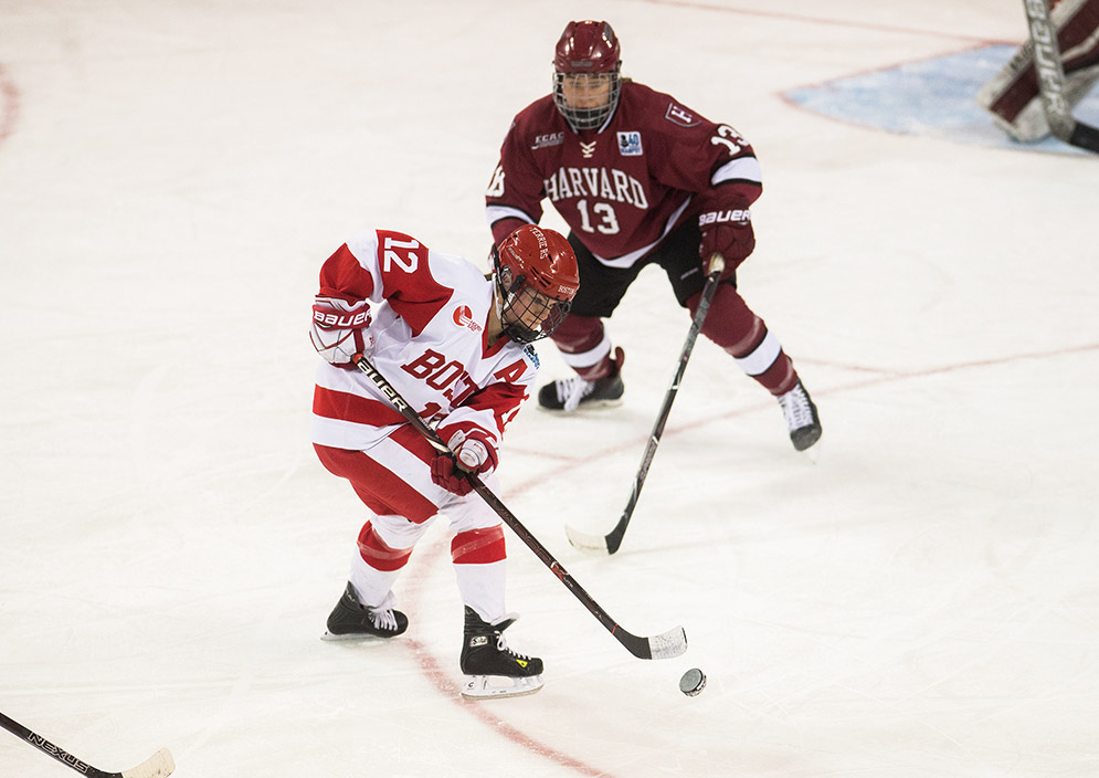 Boston University Terriers player Victoria Bach skates the puck against Harvard University's Ali Peper during the first round of the Beanpot tournament on Tuesday, February 6, 2018.