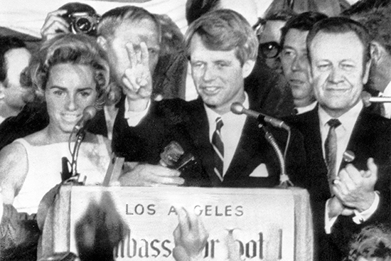 Robert F Kennedy holds two fingers up in a victory sign as he talks to campaign workers at the Ambassador Hotel in Los Angeles, prior to his assassination.