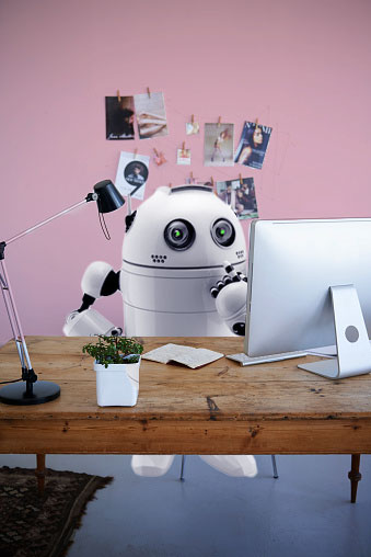 digital composite of a robot working at a desk