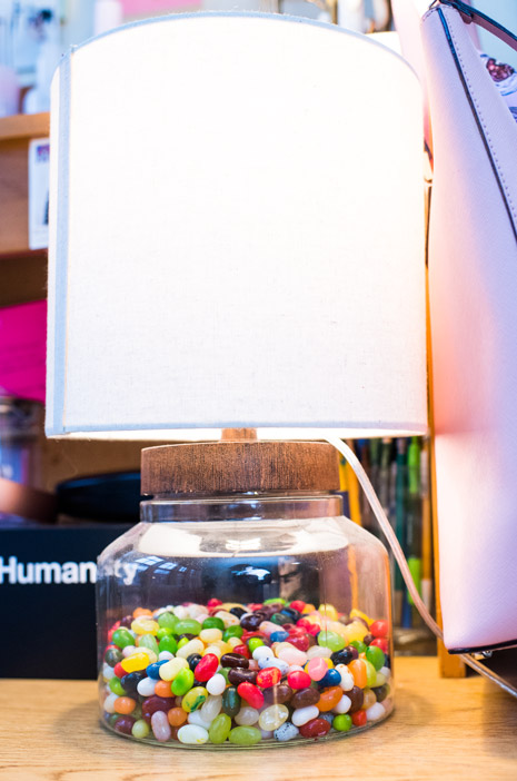 A lamp that has jelly beans in the base.