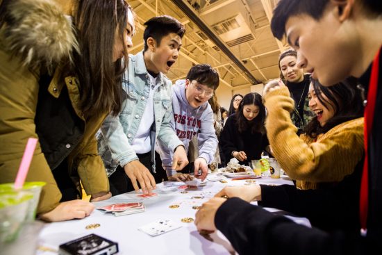 Students play a card game during a festival celebrating the Lunar New Year