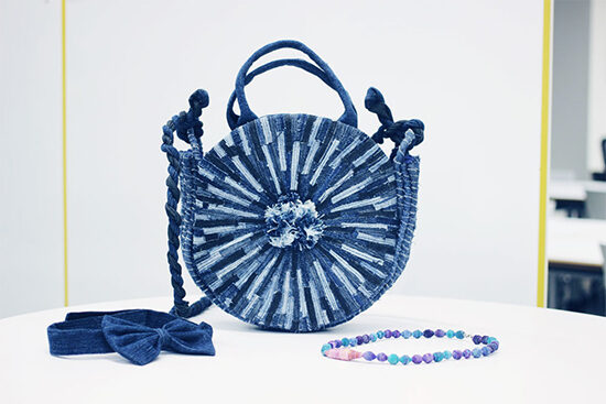 A Blue Circle Bag hand made by Make Fashion Clean on display.