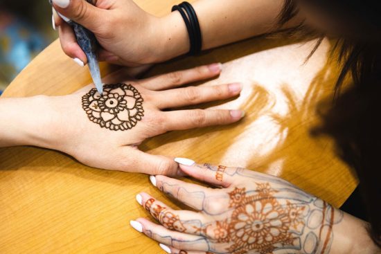 henna being drawn on a hand