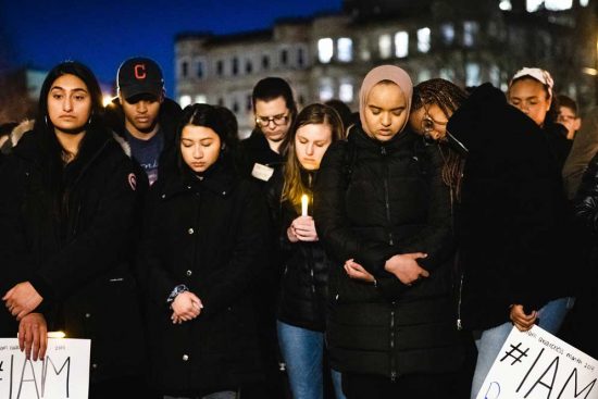 Boston University students mourn the loss of the New Zealand mosque shooting victims during a vigil on Marsh Plaza